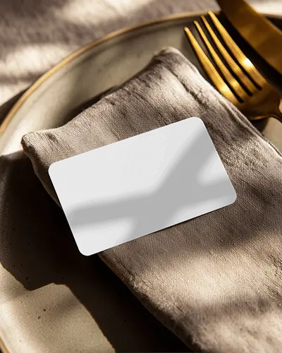 Elegant Dining Business Card Mockup On Linen Napkin With Golden Cutlery Soft Shadow