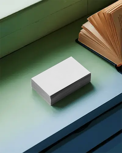 high-quality-business-card-stack-display-on-flat-surface-near-opened-classic-book