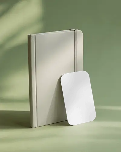 modern-corporate-business-card-mockup-standing-next-to-elastic-notebook-props