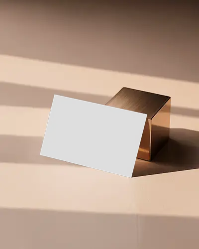 Elegant Golden Block Business Card Mockup On Beige Surface With Soft Shadows