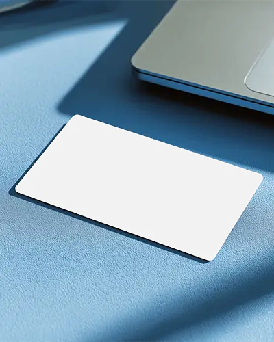 Light Blue Surface Horizontal Business Card Mockup Near Laptop Clean And Bright Modern Style