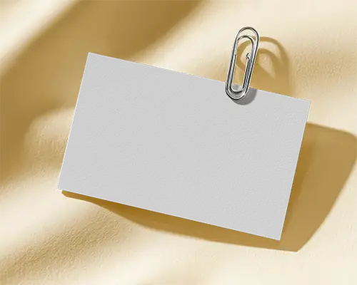 Professional Horizontal Business Card Mockup Held By Metal Paperclip In Studio