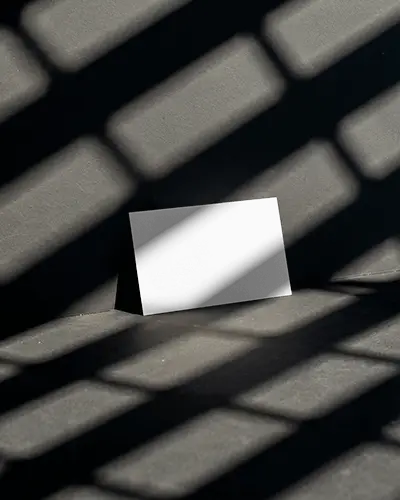 Dramatic Shadow Business Card Mockup On Dark Floor With Angled Grid Lighting
