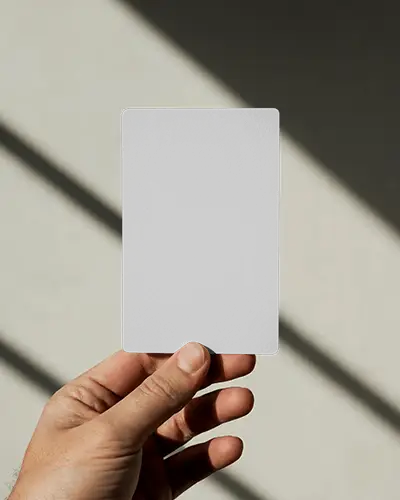 Hand Holding Vertical Business Card Mockup In Sunlight With Shadow Striped Wall
