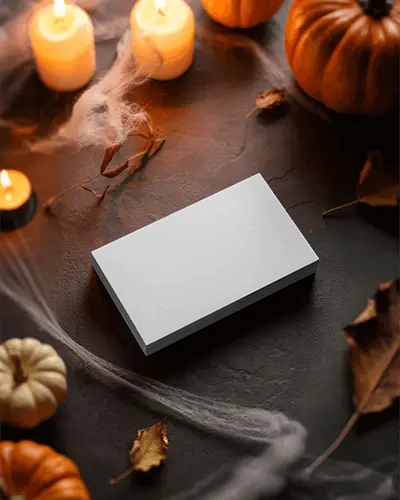 Halloween Business Card Mockup On Dark Stone With Candles Cobwebs And Autumn Leaves