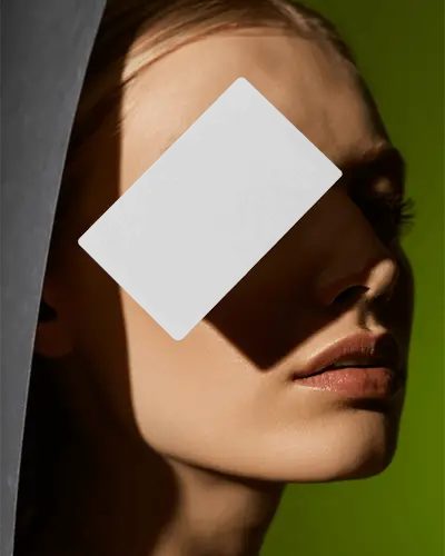 Elegant Business Card Mockup Floating Over Model Face With Dramatic Light And Shadow Effect