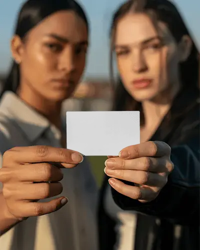 Professional Business Card Mockup Held By Two Women Showcasing Minimalist Blank Card Design