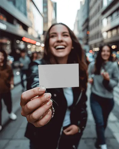 Woman Holding Blank Business Card On Busy City Street For Clear Message Display