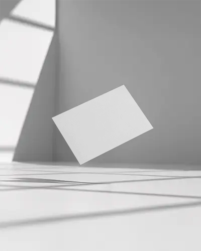 minimal-business-card-mockup-hovering-above-white-floor-with-angled-light-and-sharp-shadows