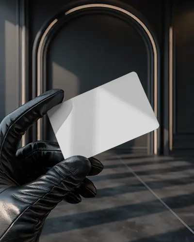 cinematic-business-card-rounded-mockup-in-gloved-hand-in-deep-toned-architectural-background