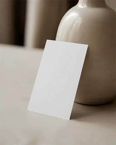 minimalist-vertical-business-card-mockup-leaning-against-ceramic-vase-elegant-styling