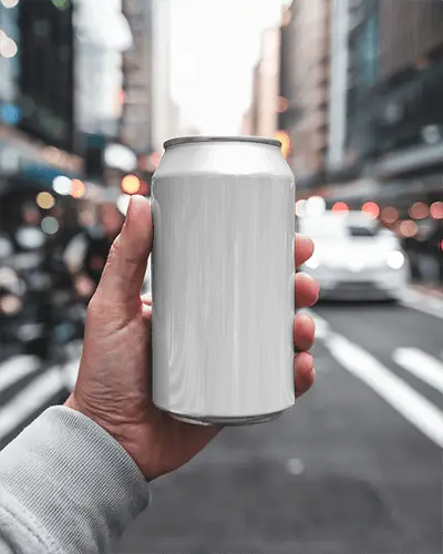 Hand Holding Can In Urban Roadside Environment With City Background For Outdoor Brand Visualization