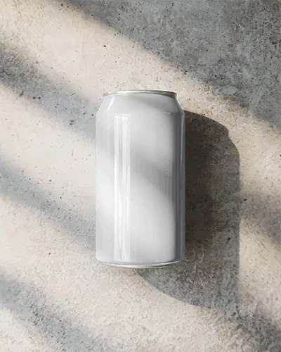 Can On Sunny Rough Texture Ground With Dramatic Shadow Play For Natural Refreshment Advertisement