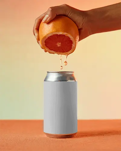Grapefruit Juice Dripping On Can Mockup Hand Holding Citrus Scene Soft Gradient Backdrop