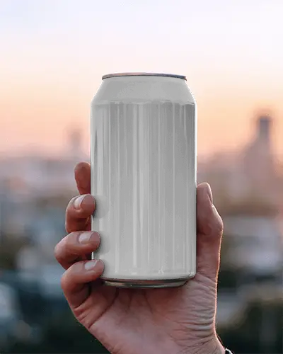 Sunset Horizon Can Mockup In Hand With Soft Sky Gradient And Warm Natural Evening Backdrop