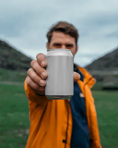 outdoor-person-showing-empty-drink-hand-holding-can-mockup-for-branding-marketing-purposes