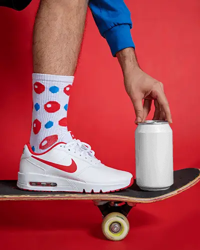 Hand Grasping Metal Can Mockup While Balancing On Skateboard For Sporty Drink