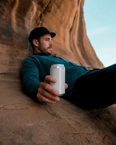 Nature Adventure Beverage Can Mockup Man Resting On Rocks Holding Drink Container