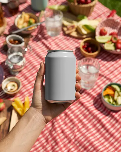 Beverage Can Mockup Showcased In Natural Light Picnic Setting With Food Background