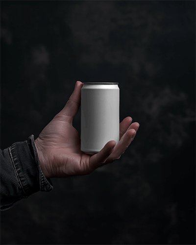Hand Holding Can Mockup In Front Of Dark Screen