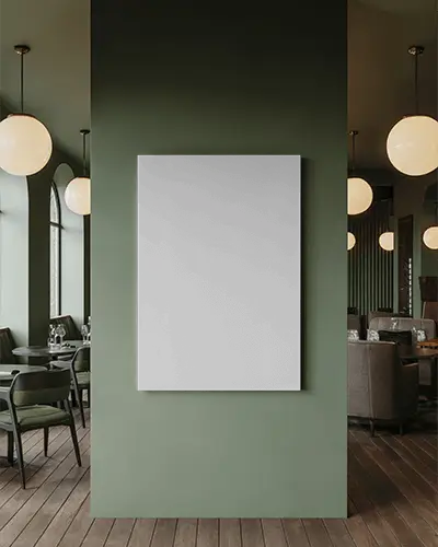 canvas-mockup-mounted-on-green-wall-in-modern-restaurant-with-round-pendant-lighting