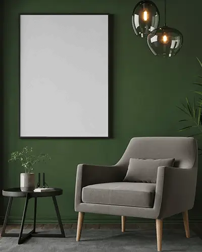 framed-canvas-mockup-on-green-wall-with-modern-armchair-round-side-table-and-hanging-lamps