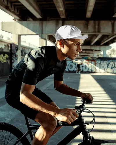 Urban Cyclist Wearing Performance Sporty Cap Mockup For Activewear Brand Promotion