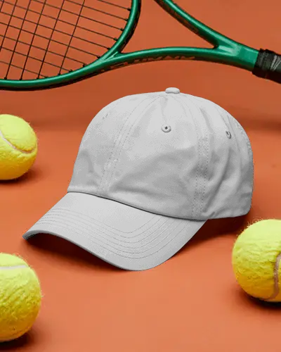 sporty-baseball-cap-mockup-dark-hat-on-orange-background-with-tennis-balls-and-racket