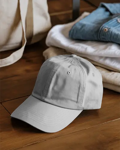 Casual Lifestyle Cap Mockup On Wooden Floor With Folded Clothes For Modern Fashion Display