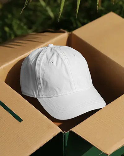 Lifestyle Cap Mockup In Cardboard Box With Sunlight Outdoor Setting Creative Modern Display