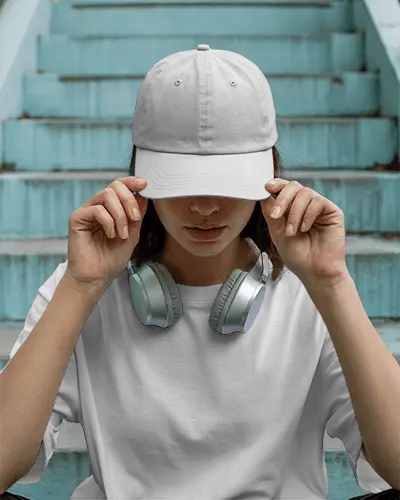 Urban Casual Cap And Tshirt Mockup Woman Adjusting Front Cap Headphones Around Neck