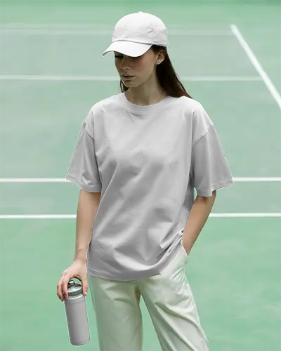 Casual Loose Fit Tshirt Mockup With Cap Holding Water Bottle At Sports Court Lifestyle