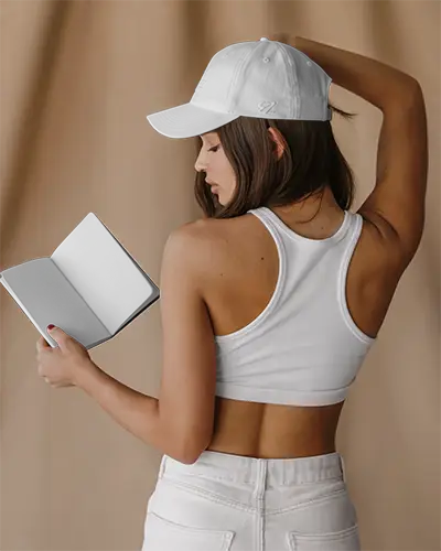 Trendy Sports Cap And Hand Holding Book Mockup Showing Back View And Modern Desig