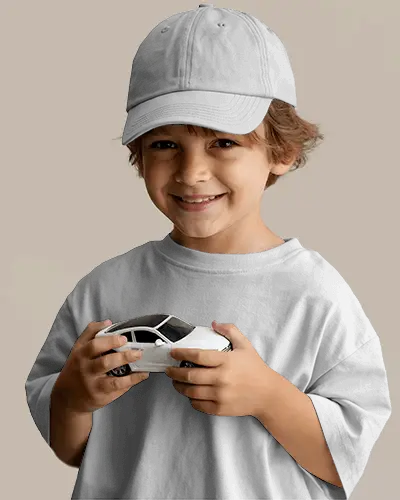 Joyful Kid Donning Casual Cap Mockup Playtime With Small Car Model