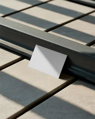 Professional Business Card Leaning Against Metal Bar With Soft Detailed Shadowing