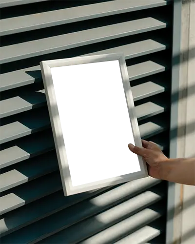 Hand Holding Blank Photo Frame Against Modern Architectural Background For Design