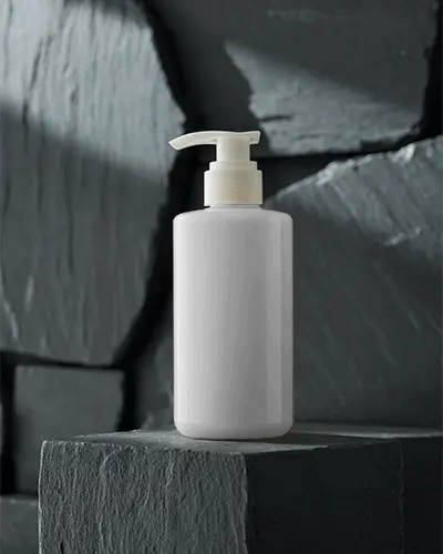 sleek-cylindrical-pump-cosmetic-bottle-standing-on-textured-stone-block-for-skin-care