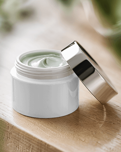 Open Cosmetic Jar Mockup Metallic Lid Reflecting Natural Light With Rich Green Cream Texture