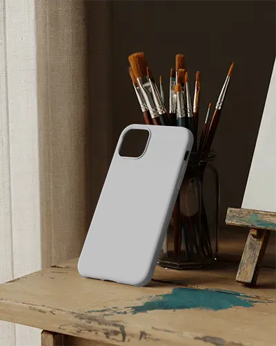 Durable Phone Cover Mockup Template On Wooden Table With Artistic Brushes Background