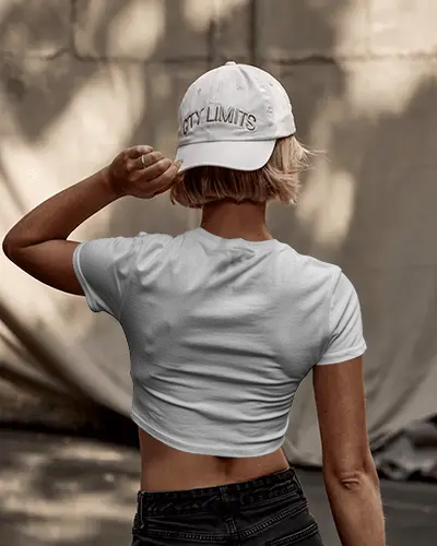 Back View Crop Top Mockup Woman In Stylish Hat Standing In Neutral Toned Background