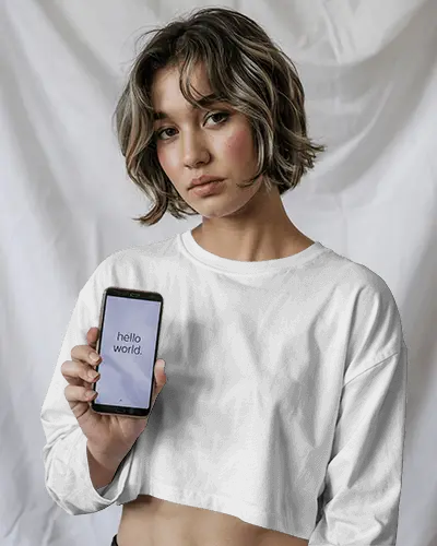 Minimal Studio Crop Top Mockup Female Model Holding Phone White Drape Background