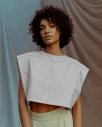 draped-backdrop-crop-top-mockup-curly-haired-model-in-boxy-top-with-soft-expression