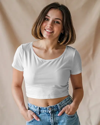 Indoor Crop Top Mockup Smiling Female Model In White Scoop Neck Tee And Denim Jeans Against Beige Fabric Backdrop
