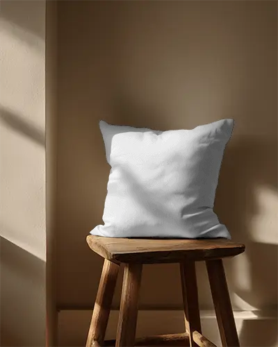 Soft Luxury Decorative Cushion Mockup On Vintage Style Wooden Stool In Natural Light