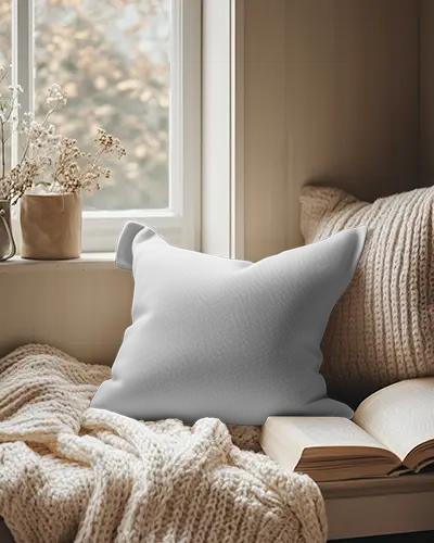 cozy-window-nook-cushion-mockup-square-pillow-on-knit-blanket-with-open-book-dried-flowers-and-soft-natural-light-warm-autumn-vibe