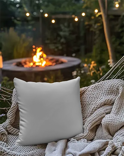 cozy-night-cushion-mockup-white-pillow-on-hammock-with-blanket-and-firepit-in-background-063