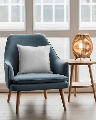 modern-living-room-cushion-mockup-on-contemporary-armchair-with-side-table-lamp-setting