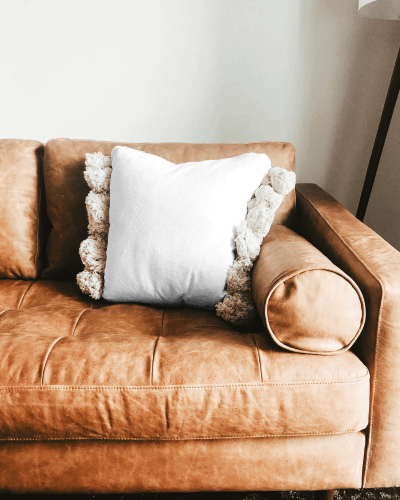 Rustic Pillow Mockup On Leather Couch