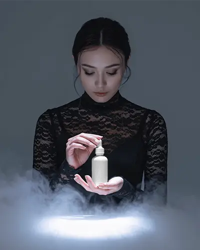 Mystical Dropper Bottle Mockup Female Model In Dark Lace With Soft Glow And Fog