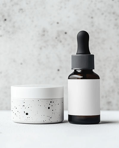 dropper-bottle-mockup-matte-amber-glass-with-black-dropper-alongside-speckled-ceramic-jar-minimalist-textured-backdrop-089
